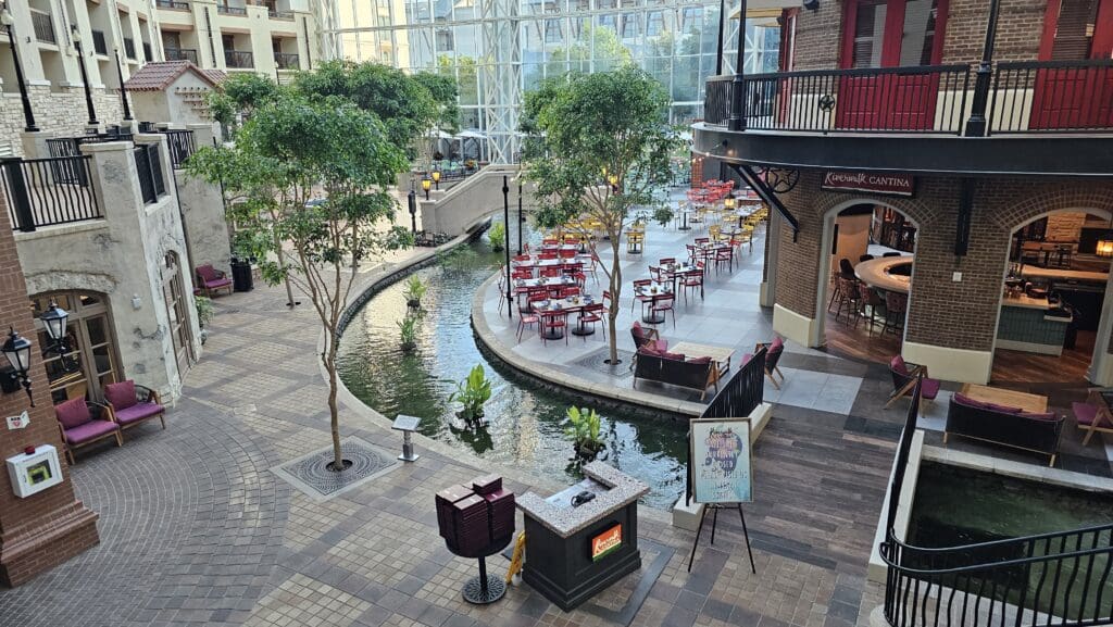 a courtyard with tables and a pond