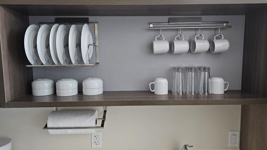 a shelf with plates and cups on it