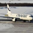 an airplane on a runway in the snow