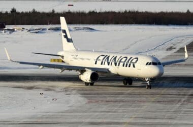 an airplane on a runway in the snow