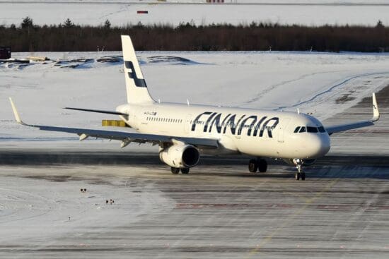 an airplane on a runway in the snow