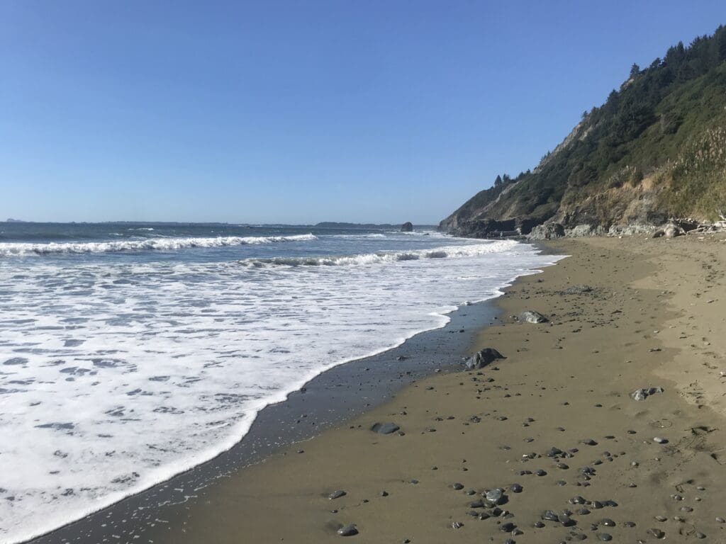 a beach with waves crashing on the shore