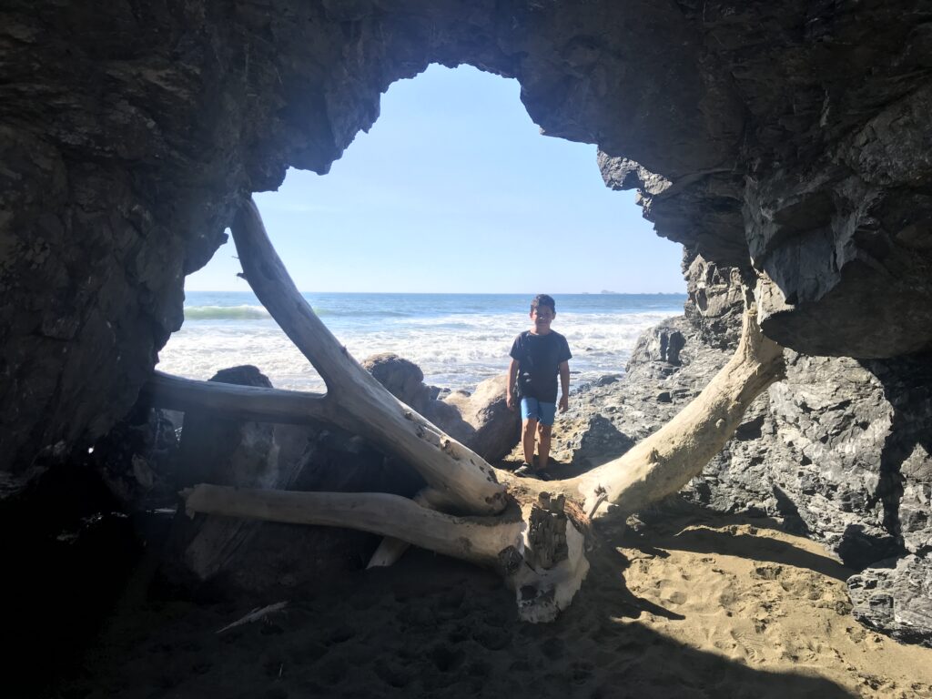 a boy standing in a cave