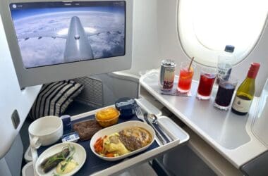 a tray of food on a table with a computer screen