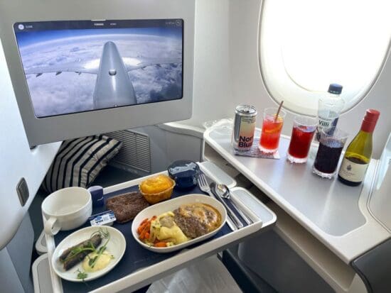 a tray of food on a table with a computer screen