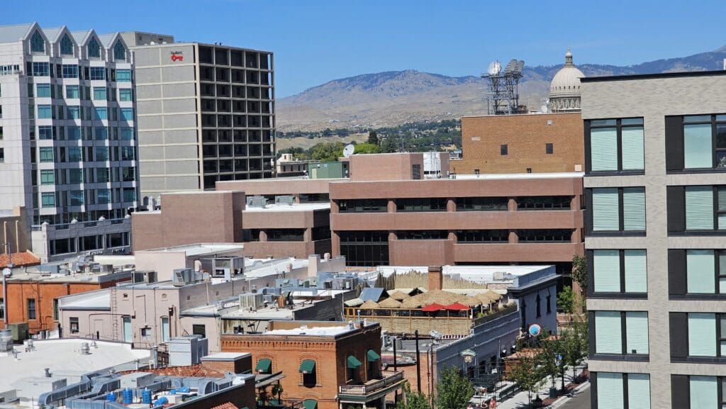 a city with buildings and mountains in the background