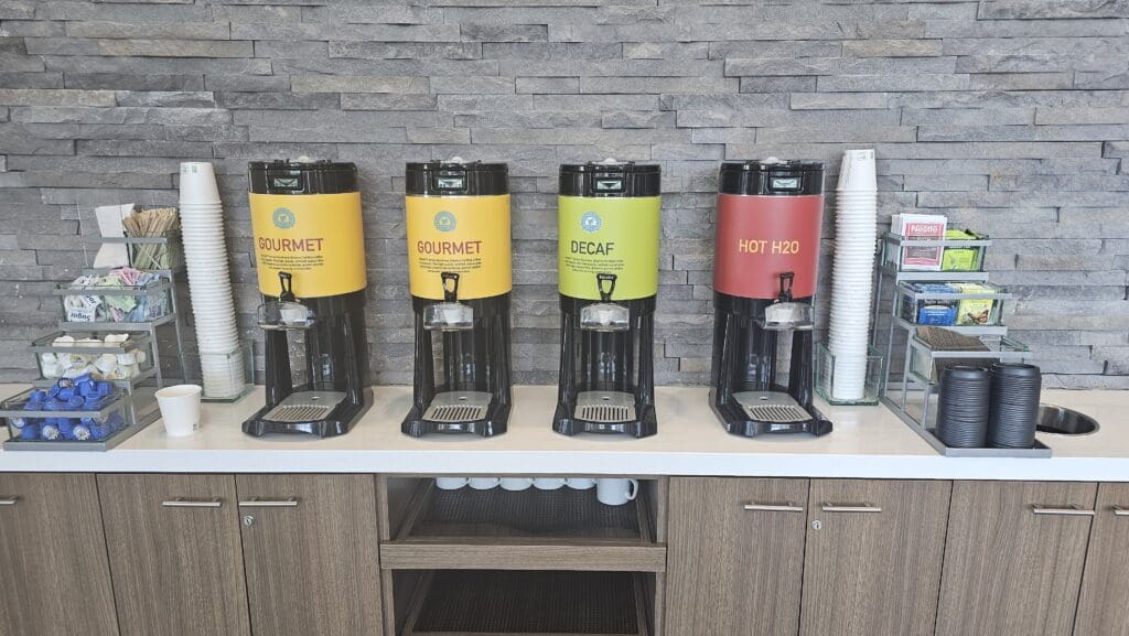 a row of coffee machines on a counter