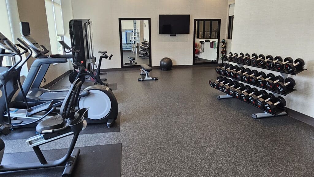 a room with exercise equipment and a mirror