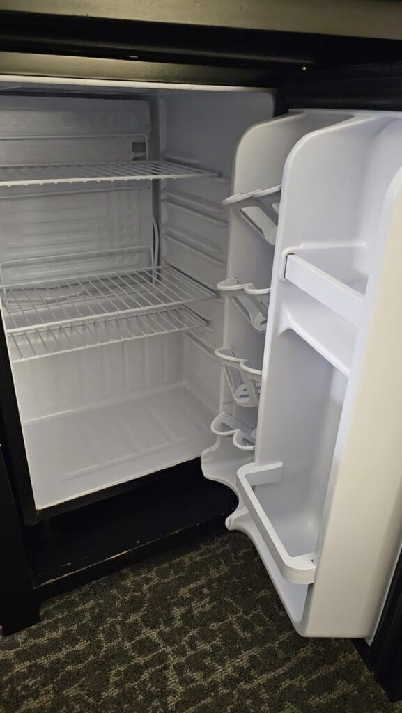 a white refrigerator with shelves