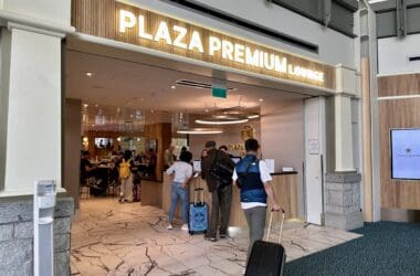 people with luggage in front of a hotel