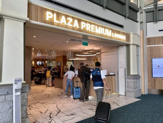 people with luggage in front of a hotel