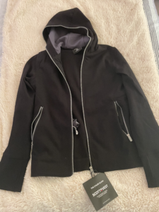 a black jacket with a tag on it