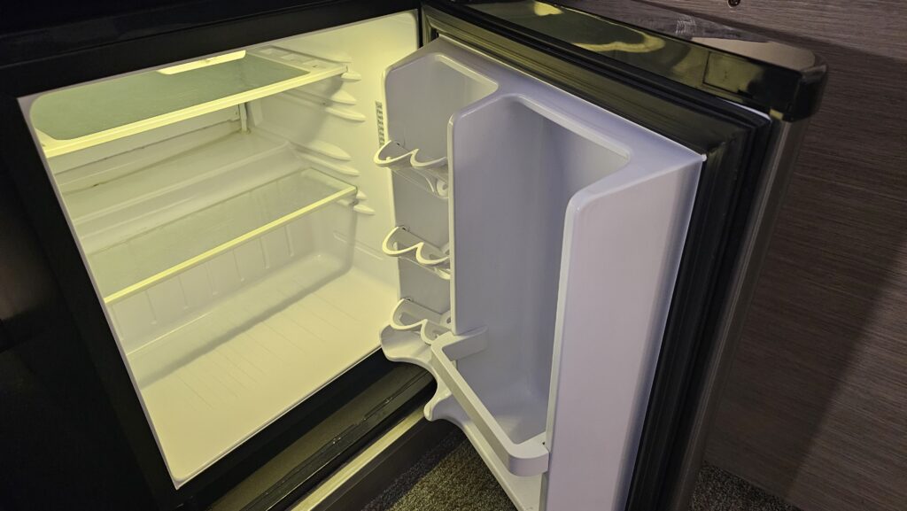 a refrigerator with a light on the door