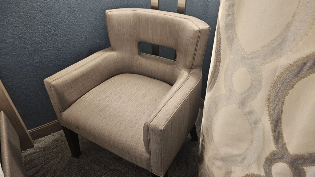 a chair next to a curtain