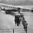 a group of people walking towards an airplane