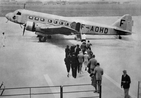 a group of people walking towards an airplane