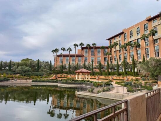 a building with trees and a body of water