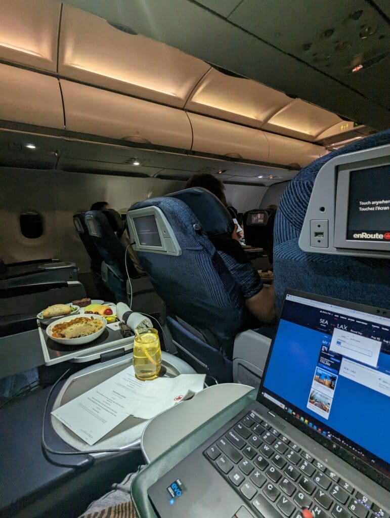 a laptop on a tray in an airplane