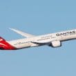 a white and red airplane flying in the sky