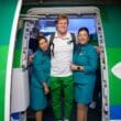 a group of people standing in a doorway of an airplane