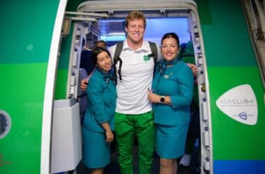 a group of people standing in a doorway of an airplane