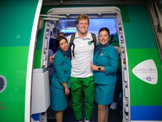 a group of people standing in a doorway of an airplane