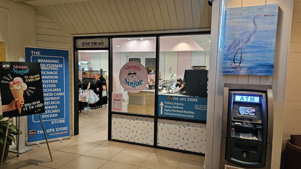 a store front with a sign on the glass door