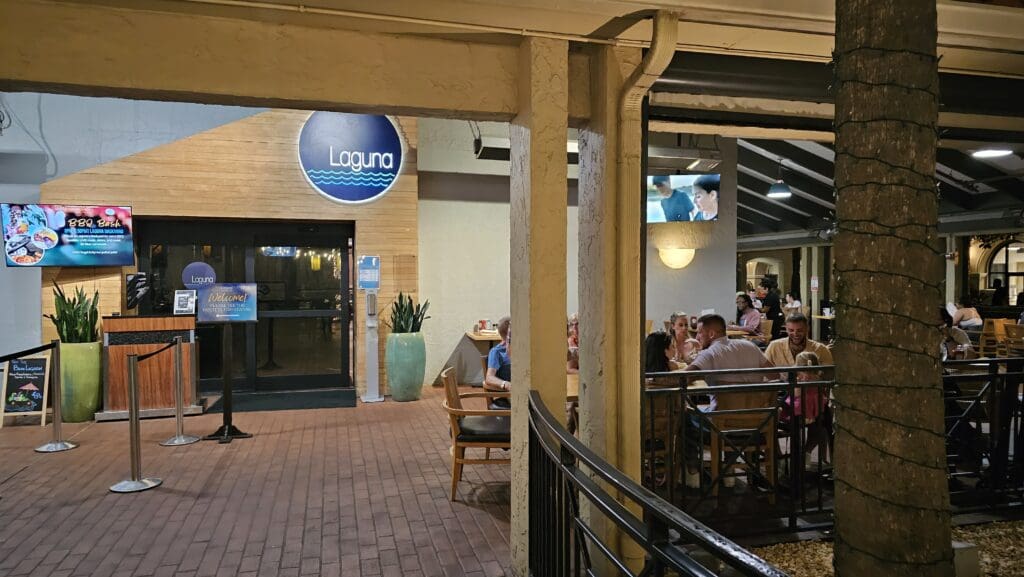 a group of people sitting at tables in a restaurant