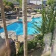 a pool with trees and a building in the background