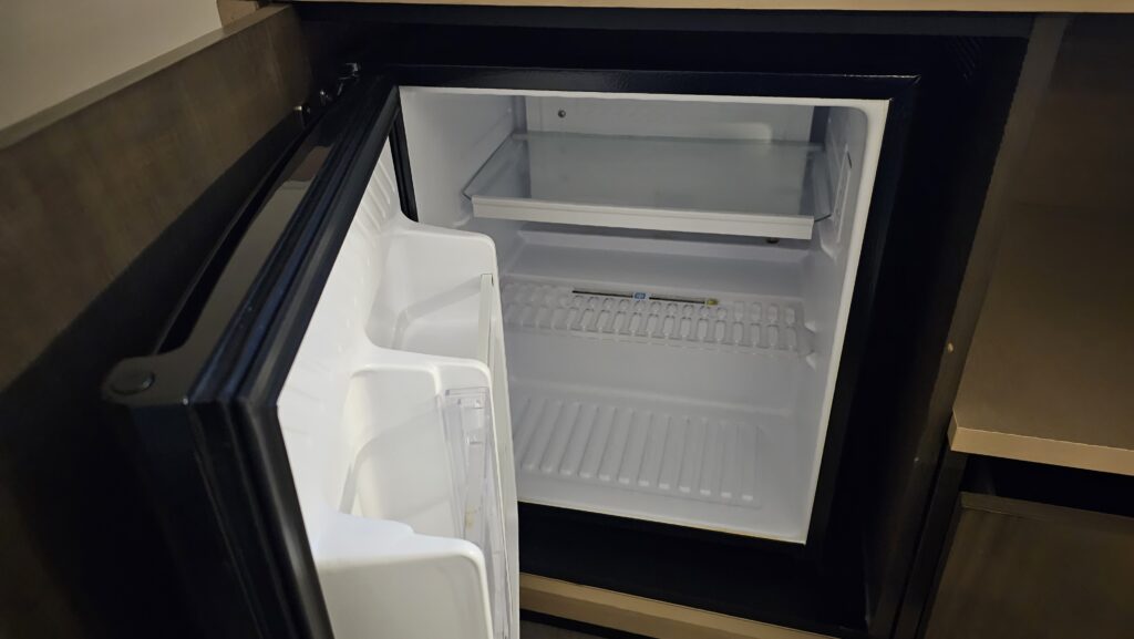 a small refrigerator with a door open