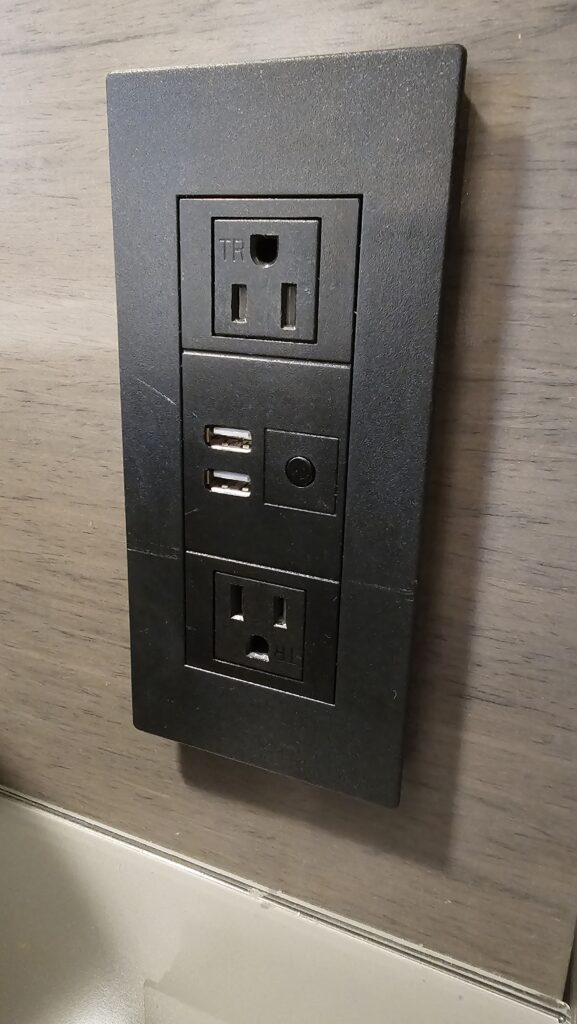 a black electrical outlet with usb ports