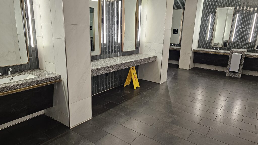 a bathroom with a yellow sign