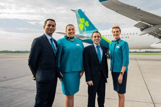 a group of people standing in front of an airplane