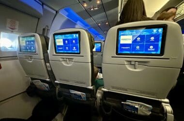 a row of seats with screens on the back