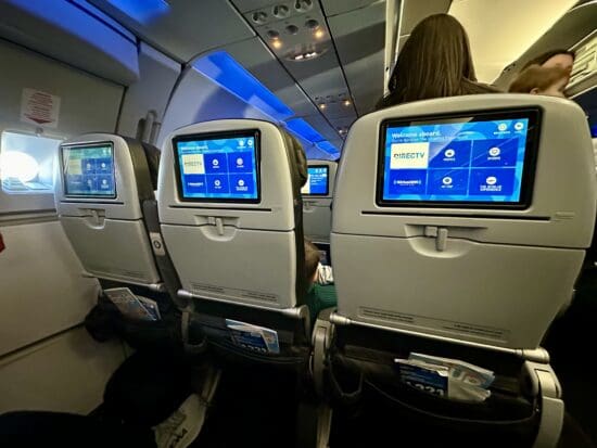 a row of seats with screens on the back