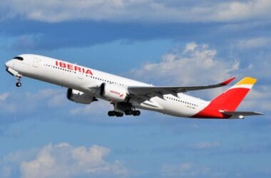 a white and red airplane flying in the sky