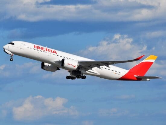 a white and red airplane flying in the sky