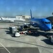 a blue airplane on the tarmac