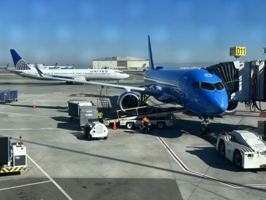 a blue airplane on the tarmac