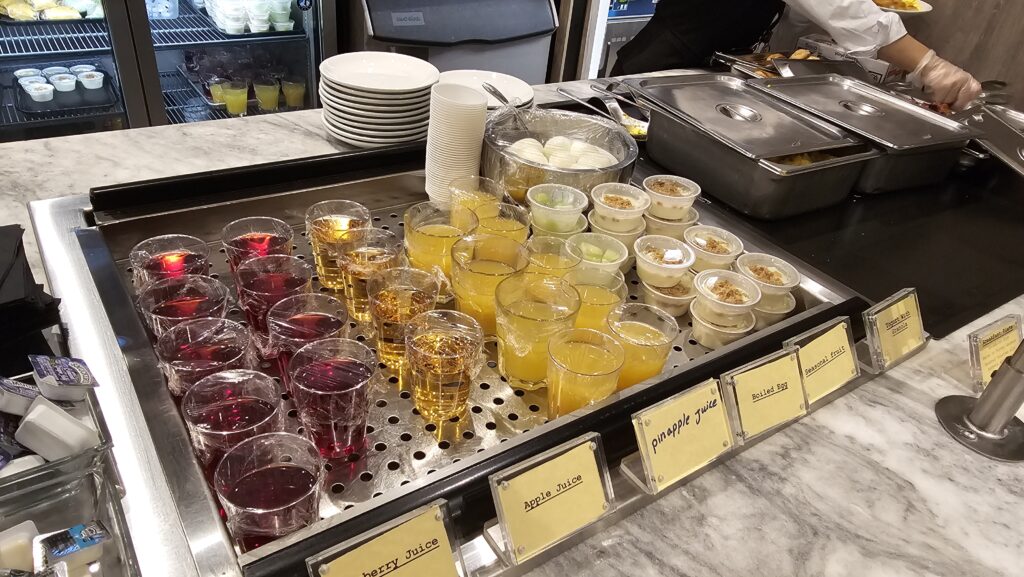 a group of glasses of liquid and other drinks on a counter