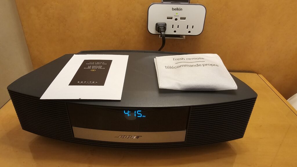 a black electronic device with a white paper on top