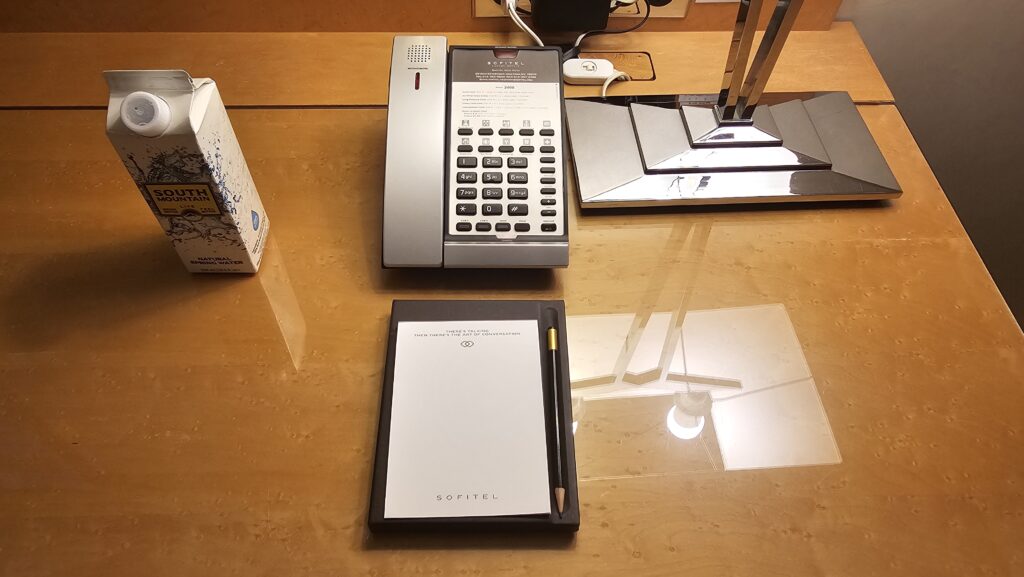 a desk with a telephone and a notepad