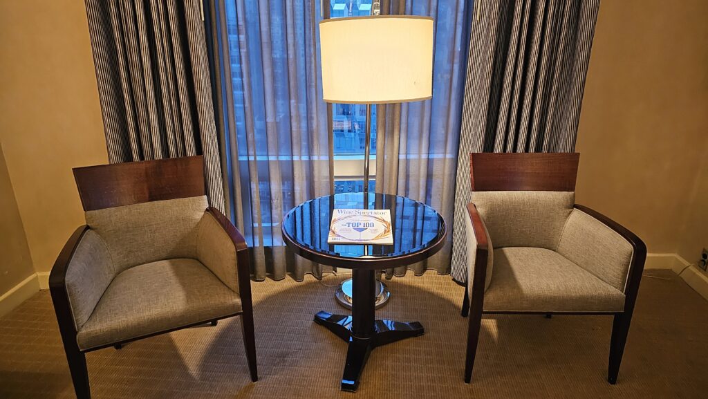 a lamp on a table next to two chairs