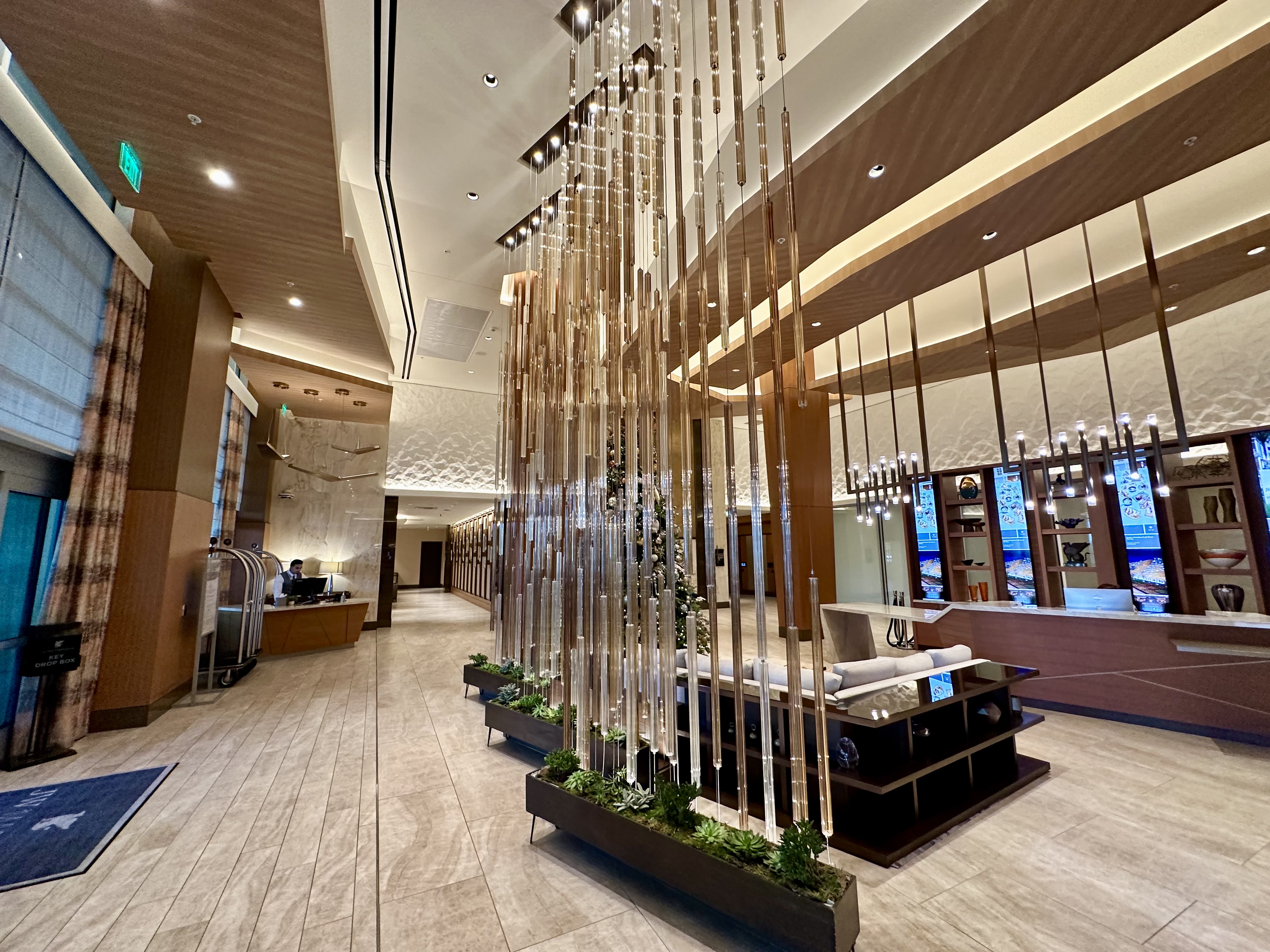 a lobby with a tall sculpture of tall metal rods