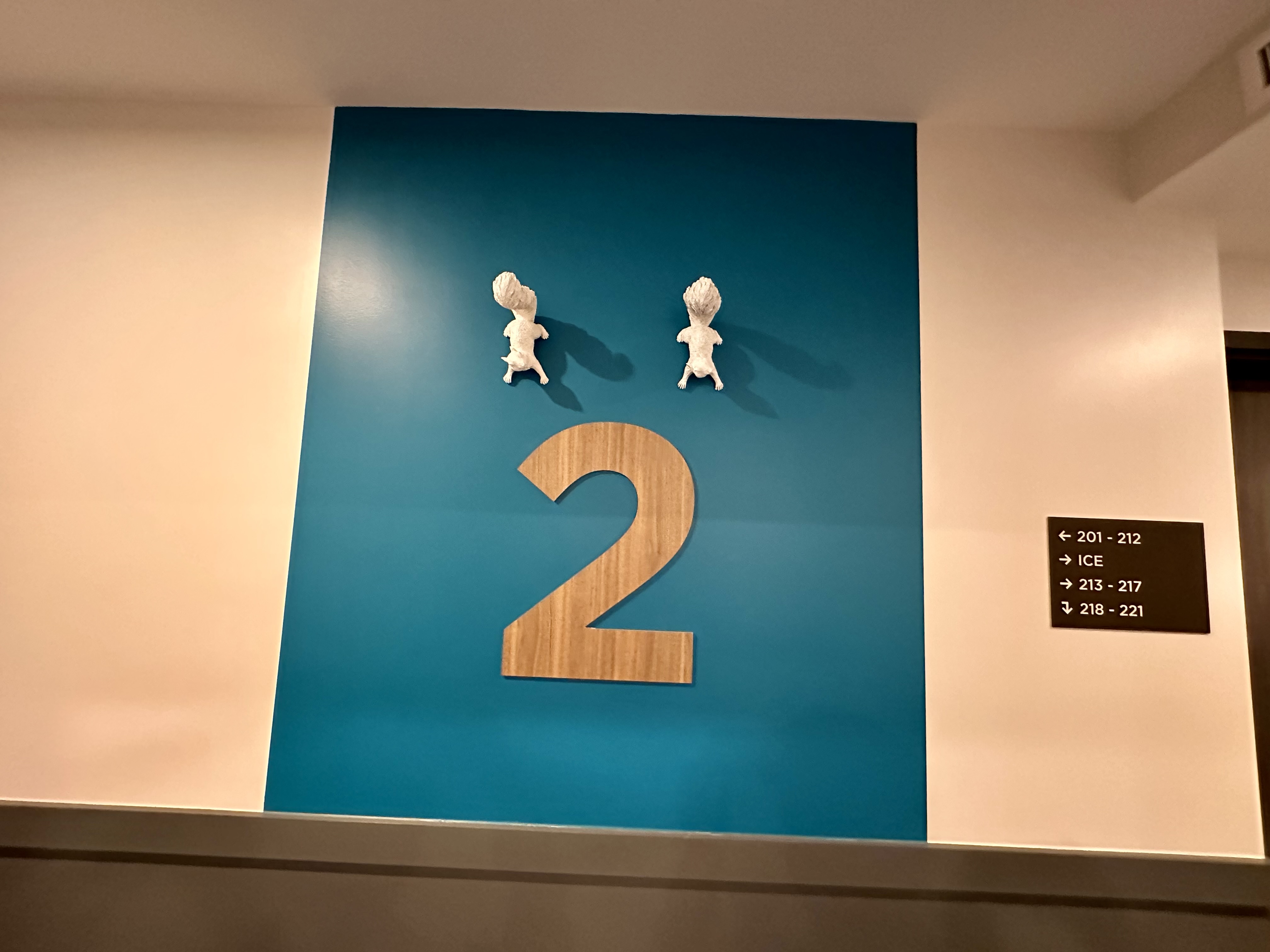 a blue wall with a number and two figures