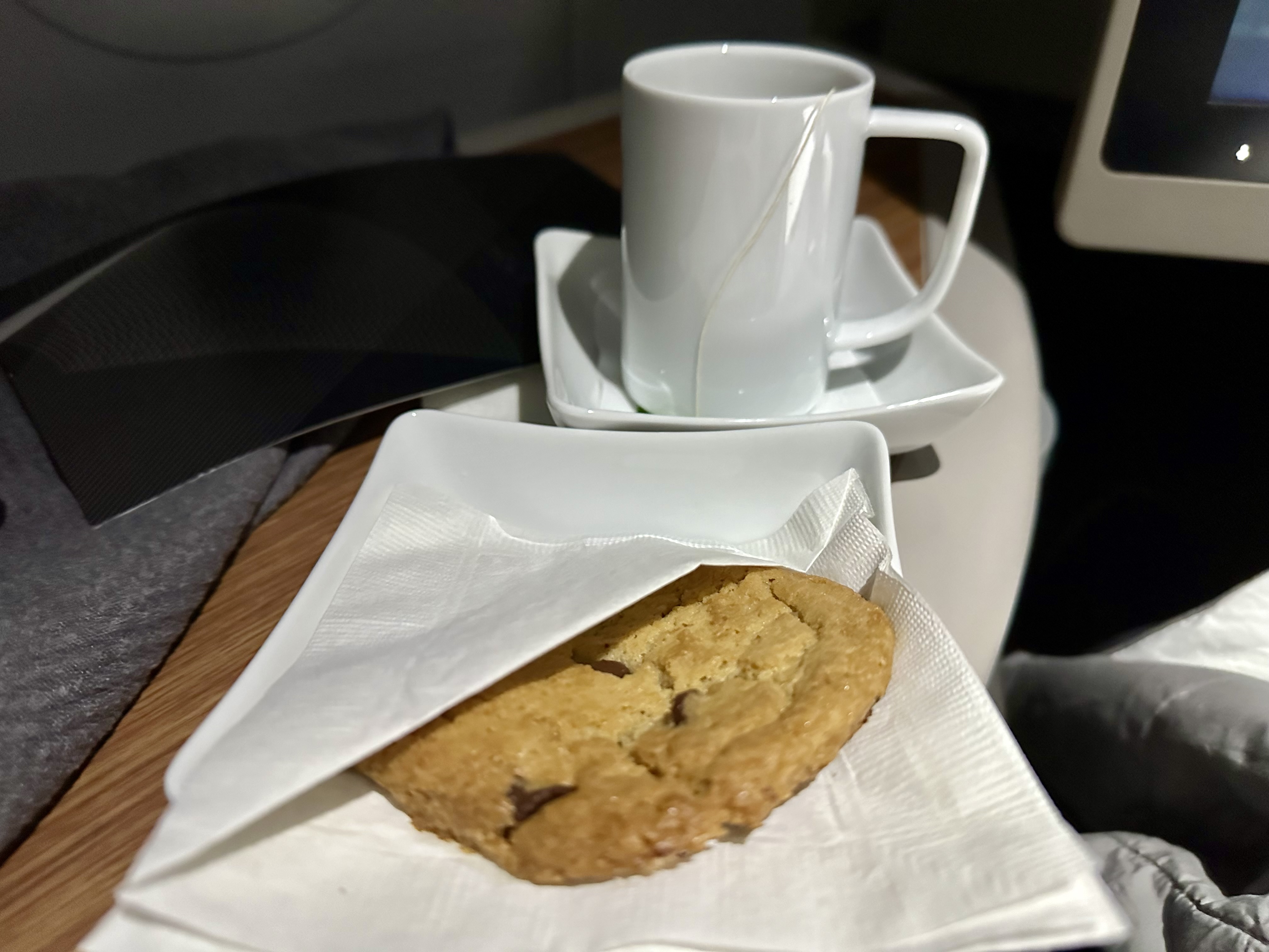a cookie and a cup on a plate