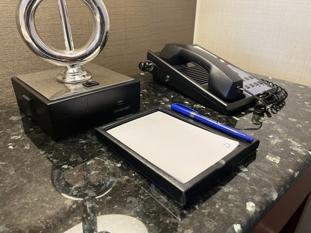 a telephone and a notepad on a counter