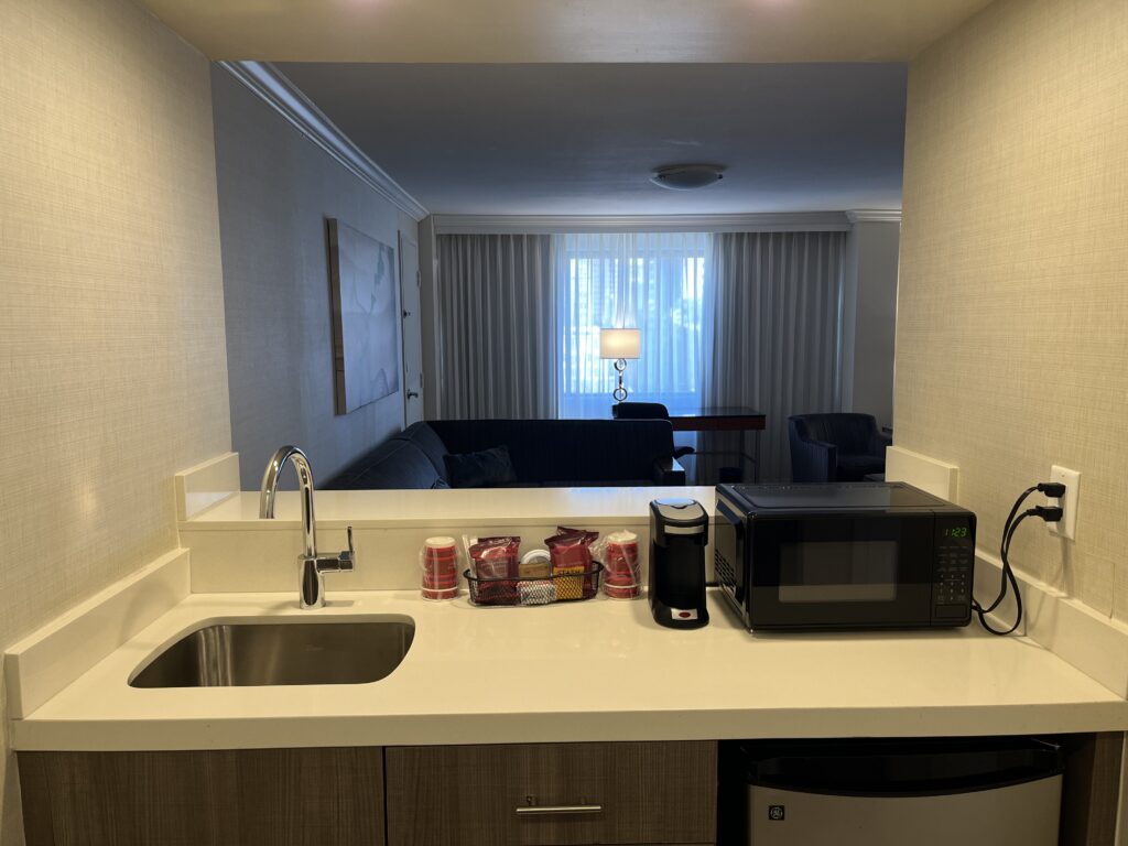 a kitchen counter with a microwave and a sink