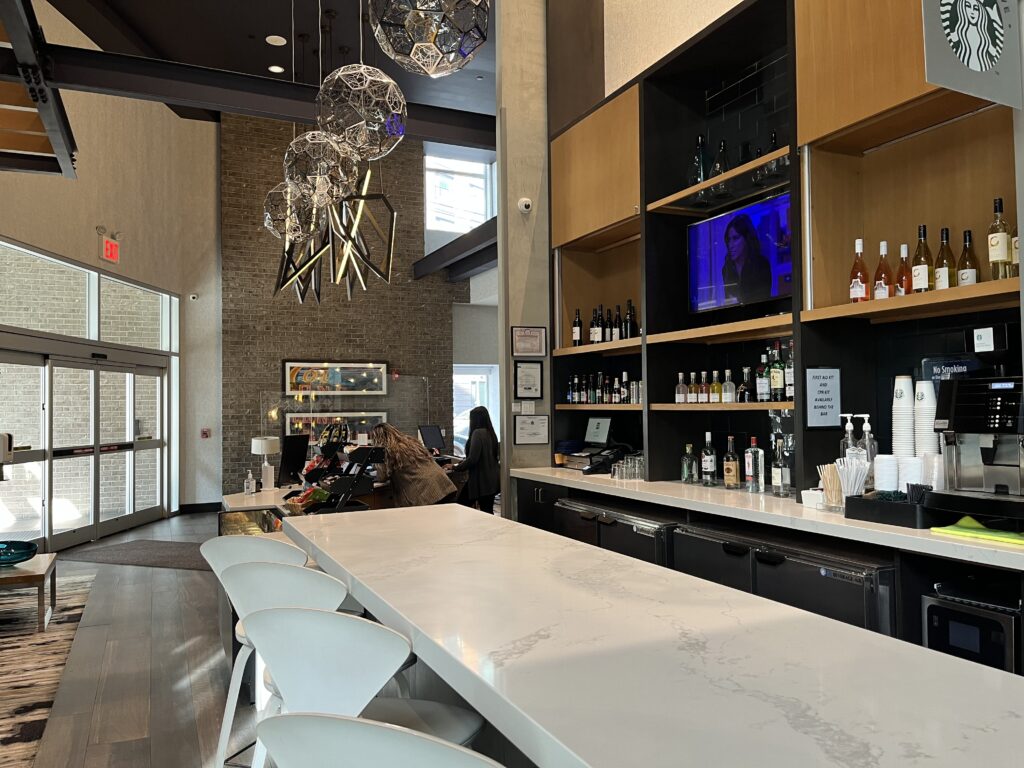 Hyatt Place Long Island City lobby bar with white counter and chairs
