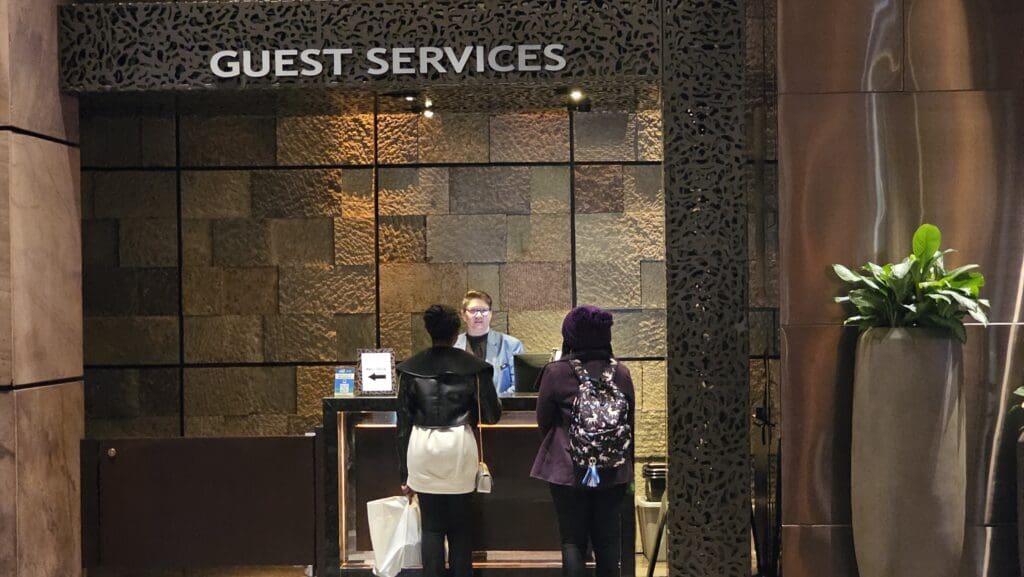 a group of people standing in front of a reception desk